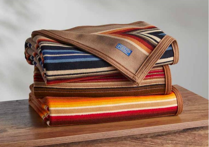 Three Pendleton Archival Serapes, folded on a table