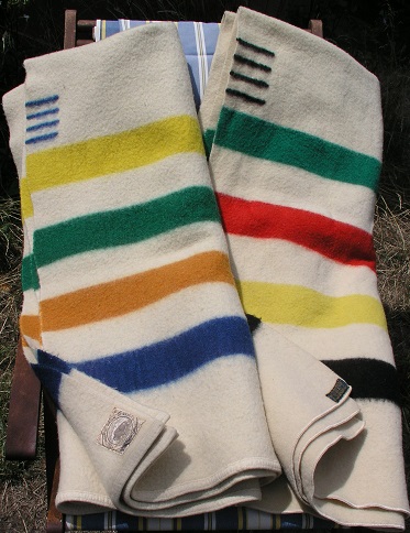 Two folded national park blankets by Pendleton, which include the points no longer used on Pendleton blankets.
